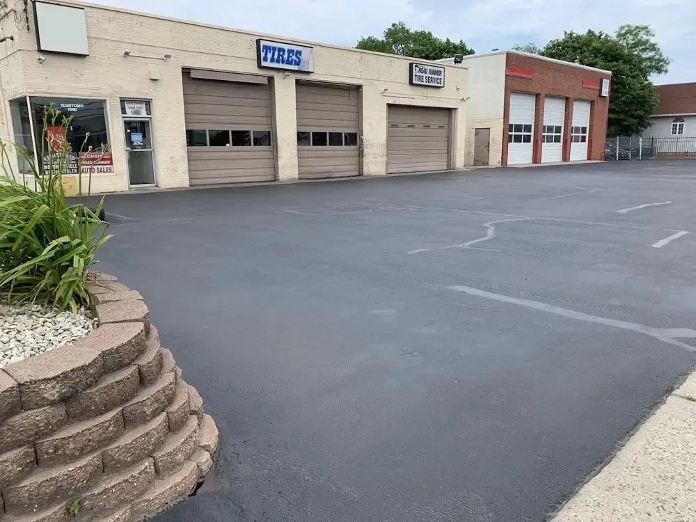 Earlier look of the Christian’s Road Runner Tire Service building with tan bay doors