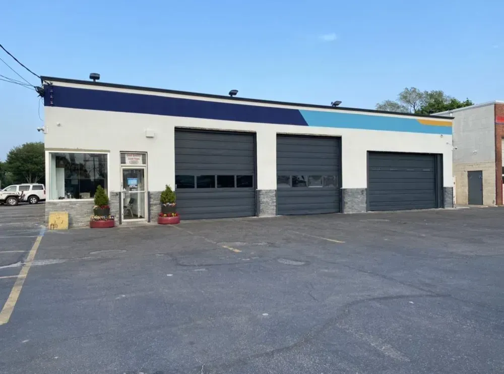 Christian’s Road Runner Tire Service building with closed bay doors and an empty parking lot
