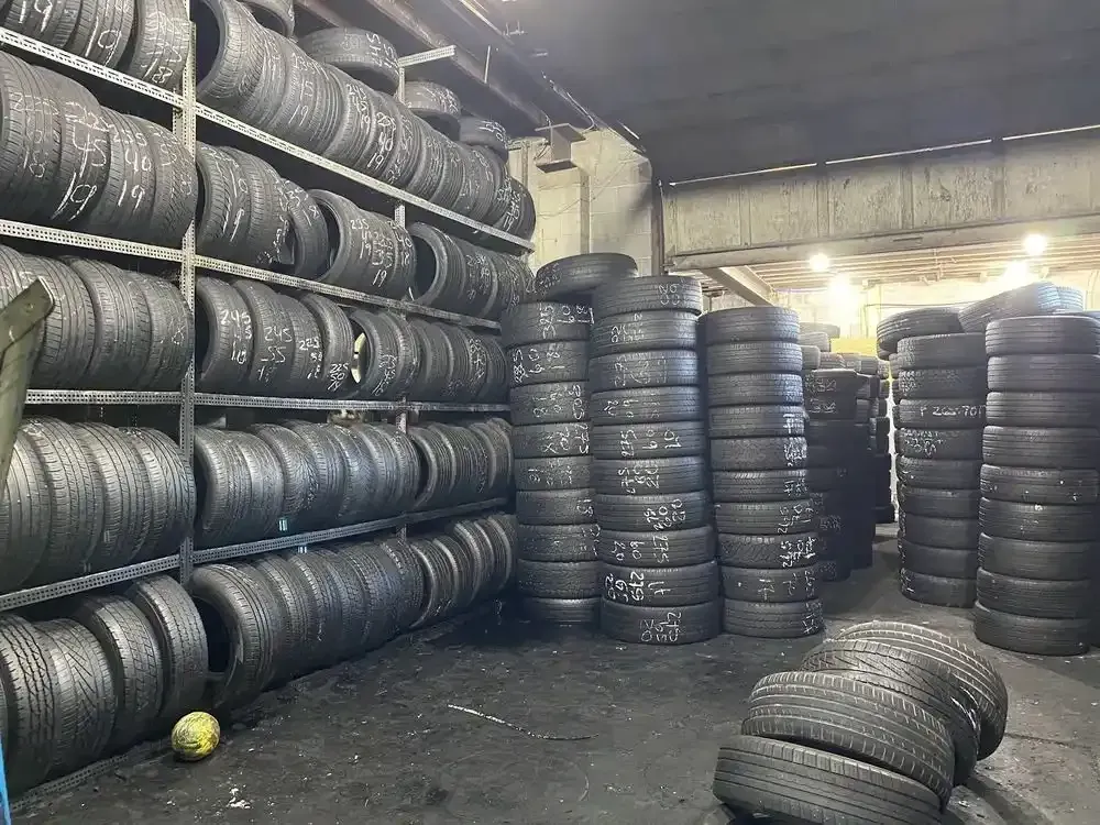 Tire storage racks and stacks of used tires along the shop floor